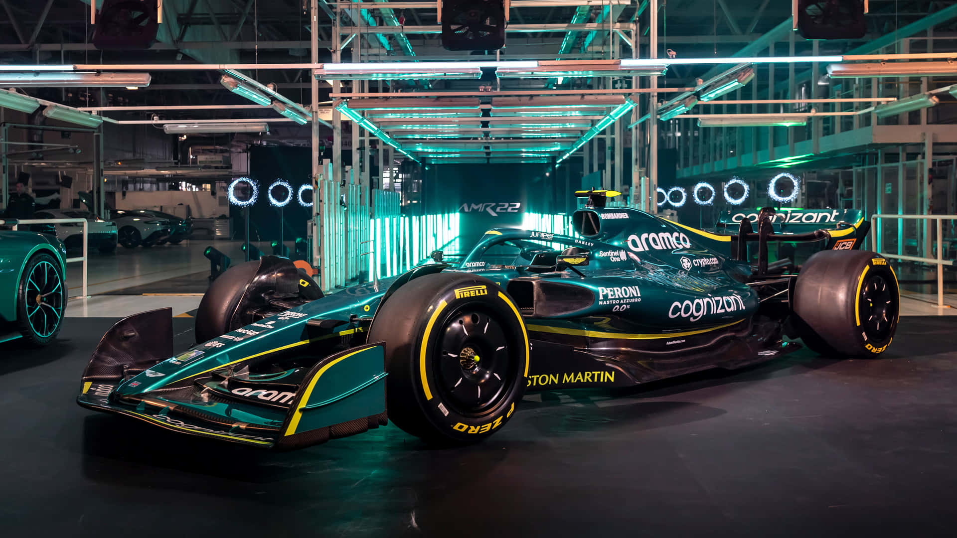 A Green Racing Car Is On Display In A Garage Wallpaper