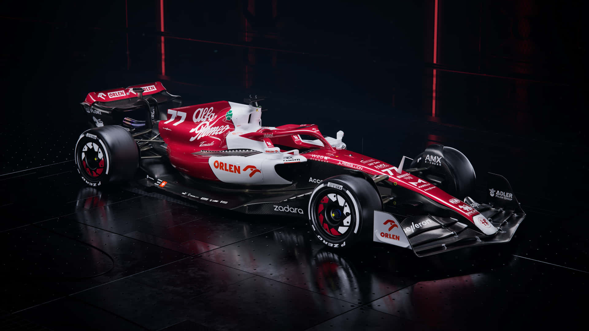 A Red And White Racing Car In A Dark Room Wallpaper