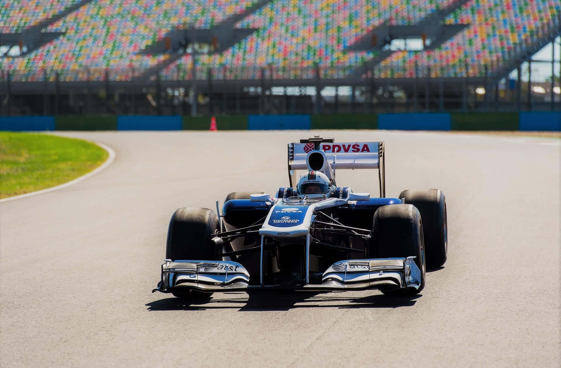 Formula1 Racecar Speedingon Track Wallpaper