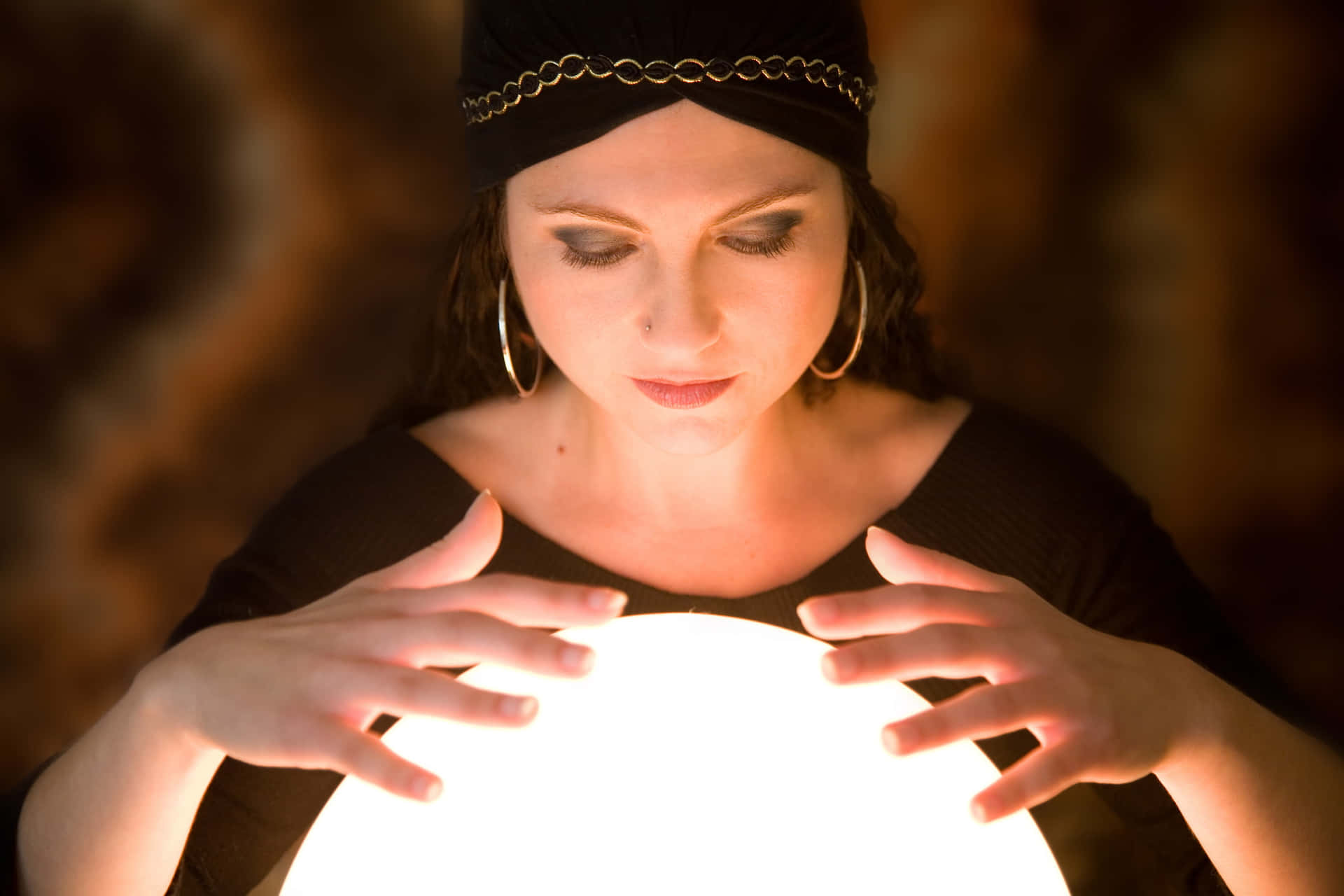 Mysterious Fortune Teller with Glowing Crystal Ball Wallpaper