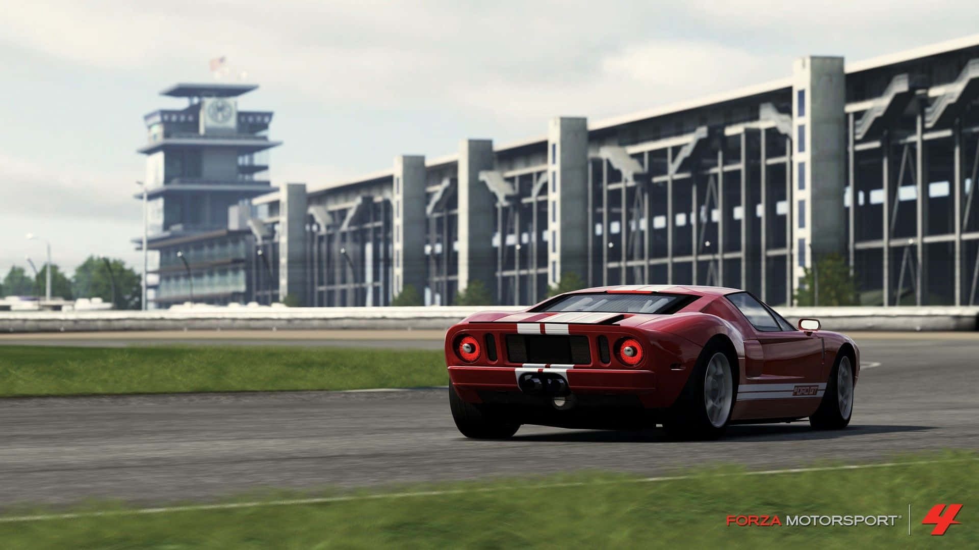 a red sports car driving on a race track Wallpaper