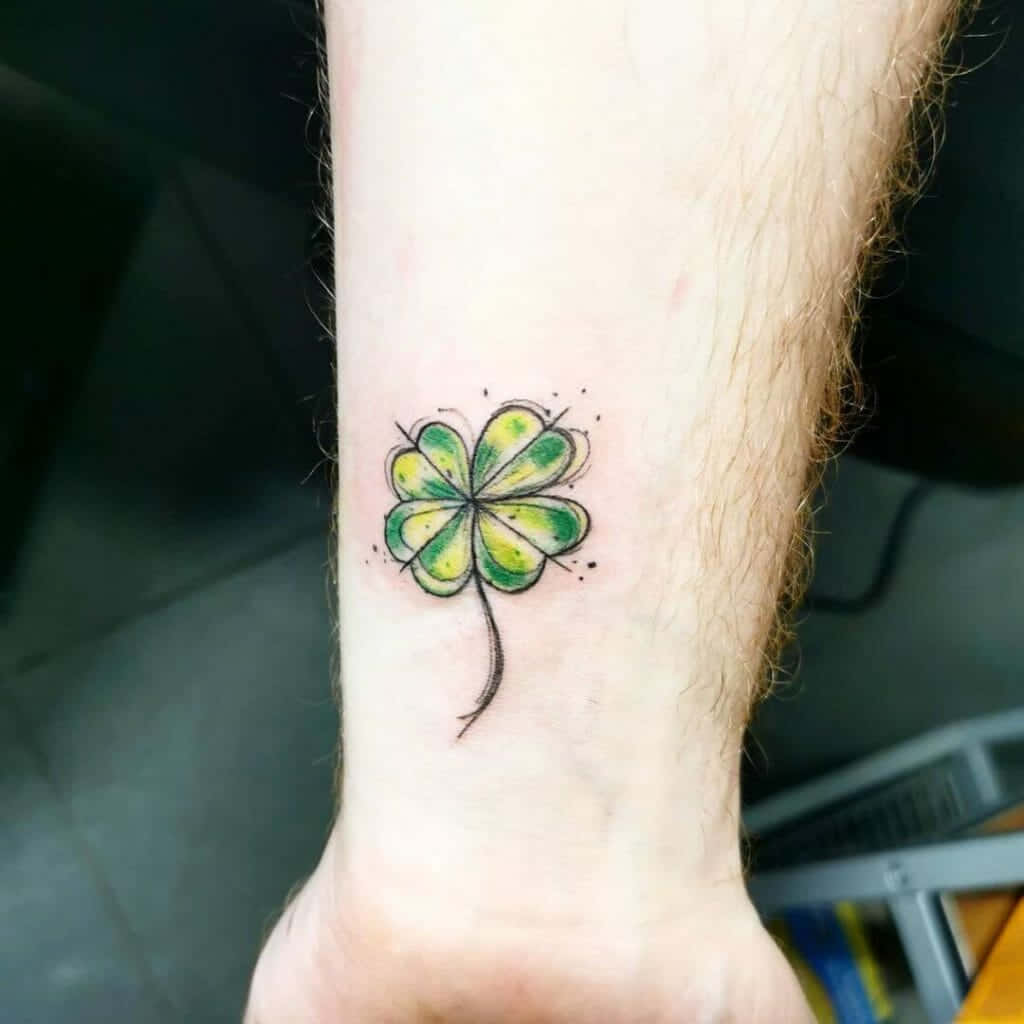 Handpoked four leaf lover tattoo located on the wrist.