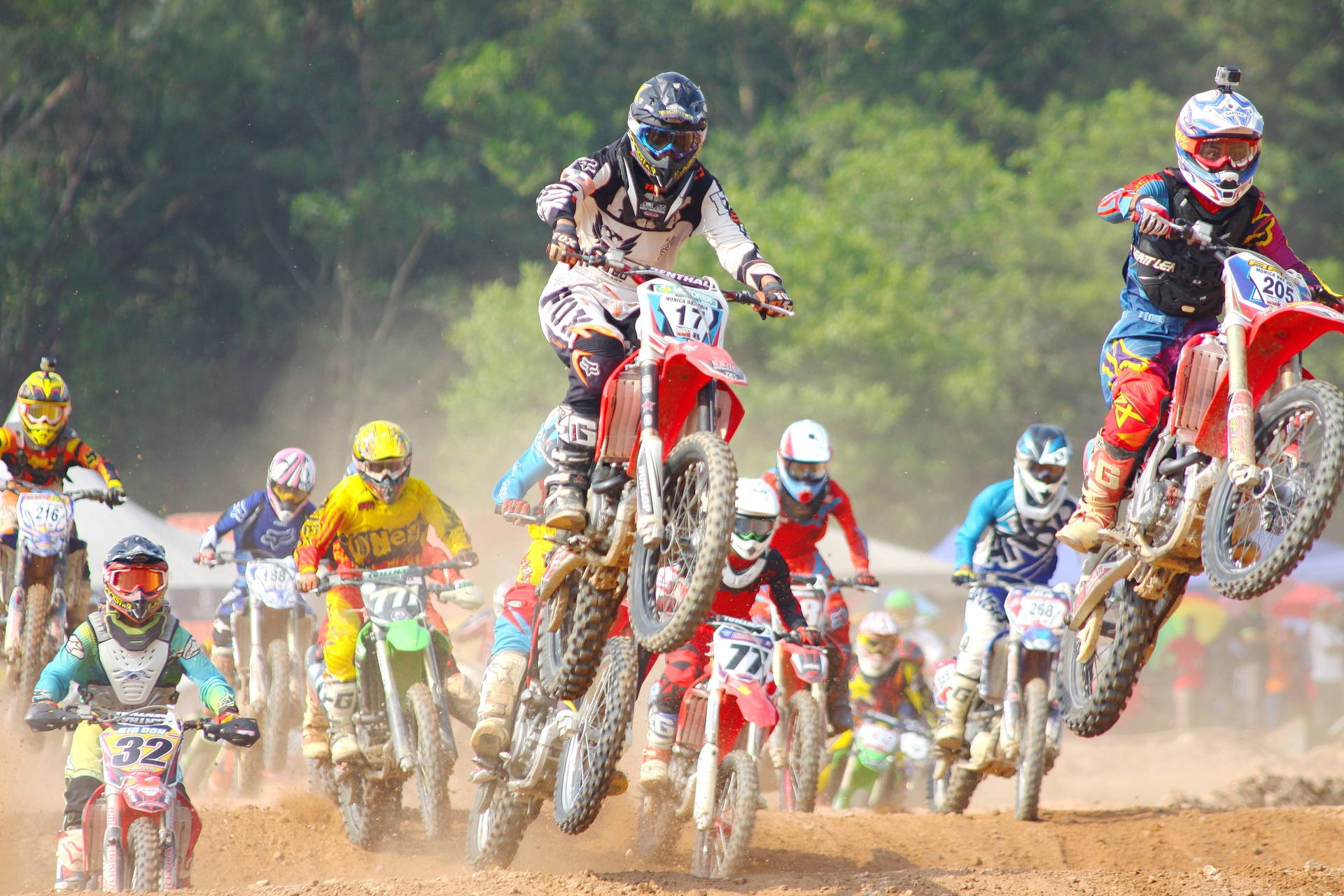 A Group Of People Riding Dirt Bikes Wallpaper