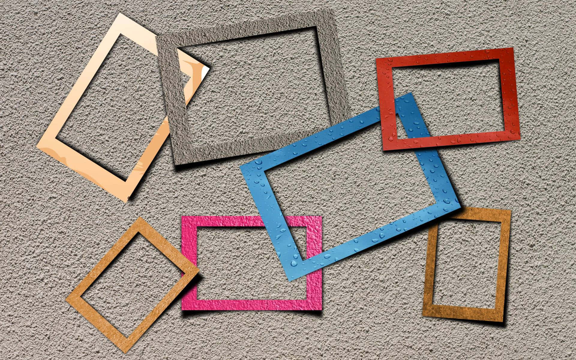 a group of colored frames on a concrete wall
