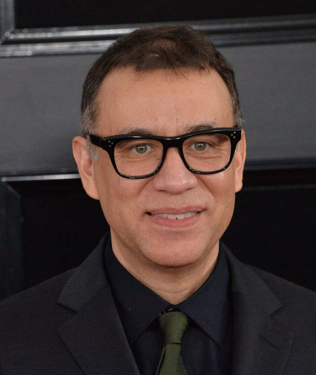 Comedian-actor Fred Armisen in a yellow and black hoodie. Wallpaper