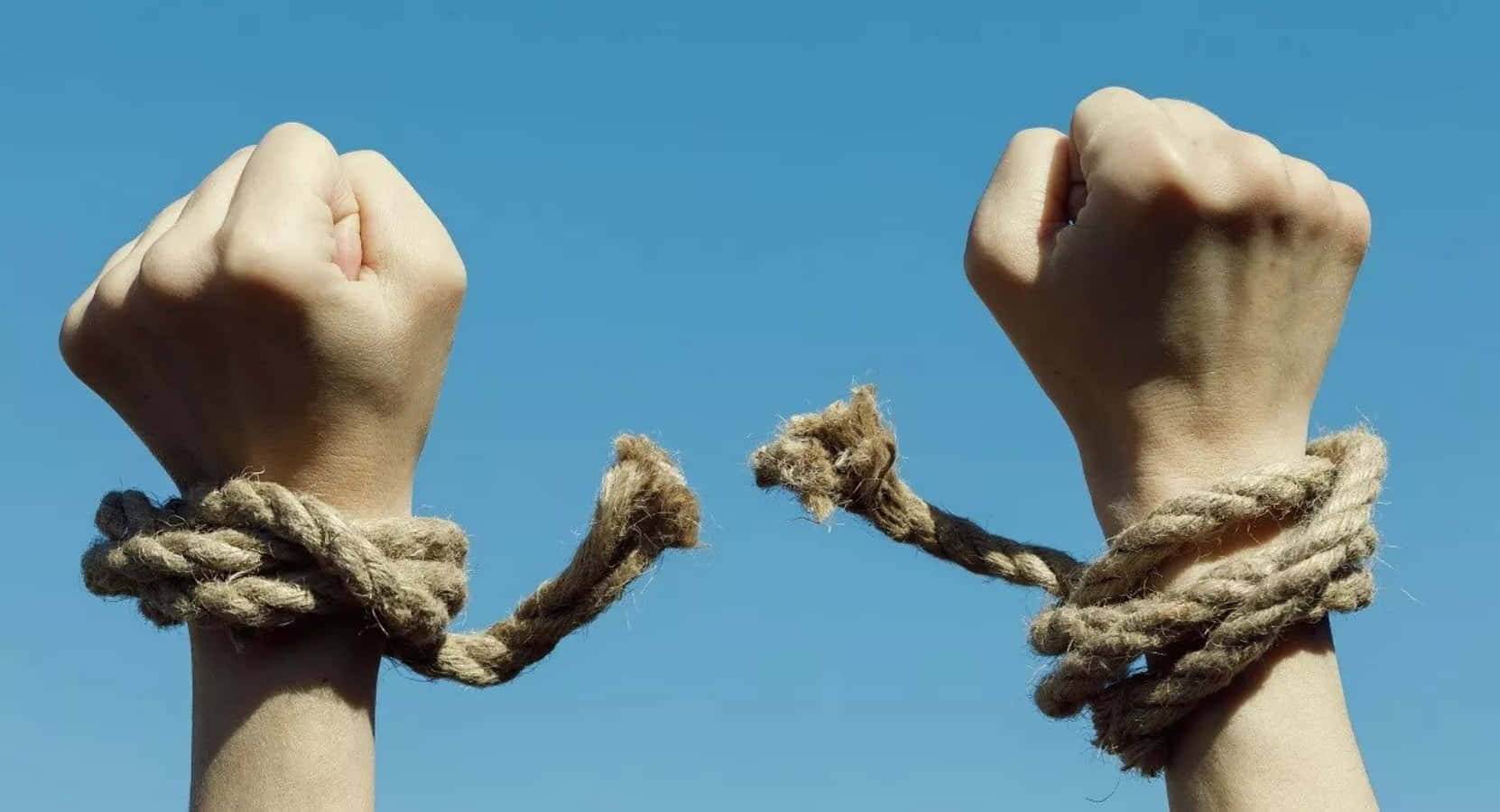 Two Hands Tied Up With Rope