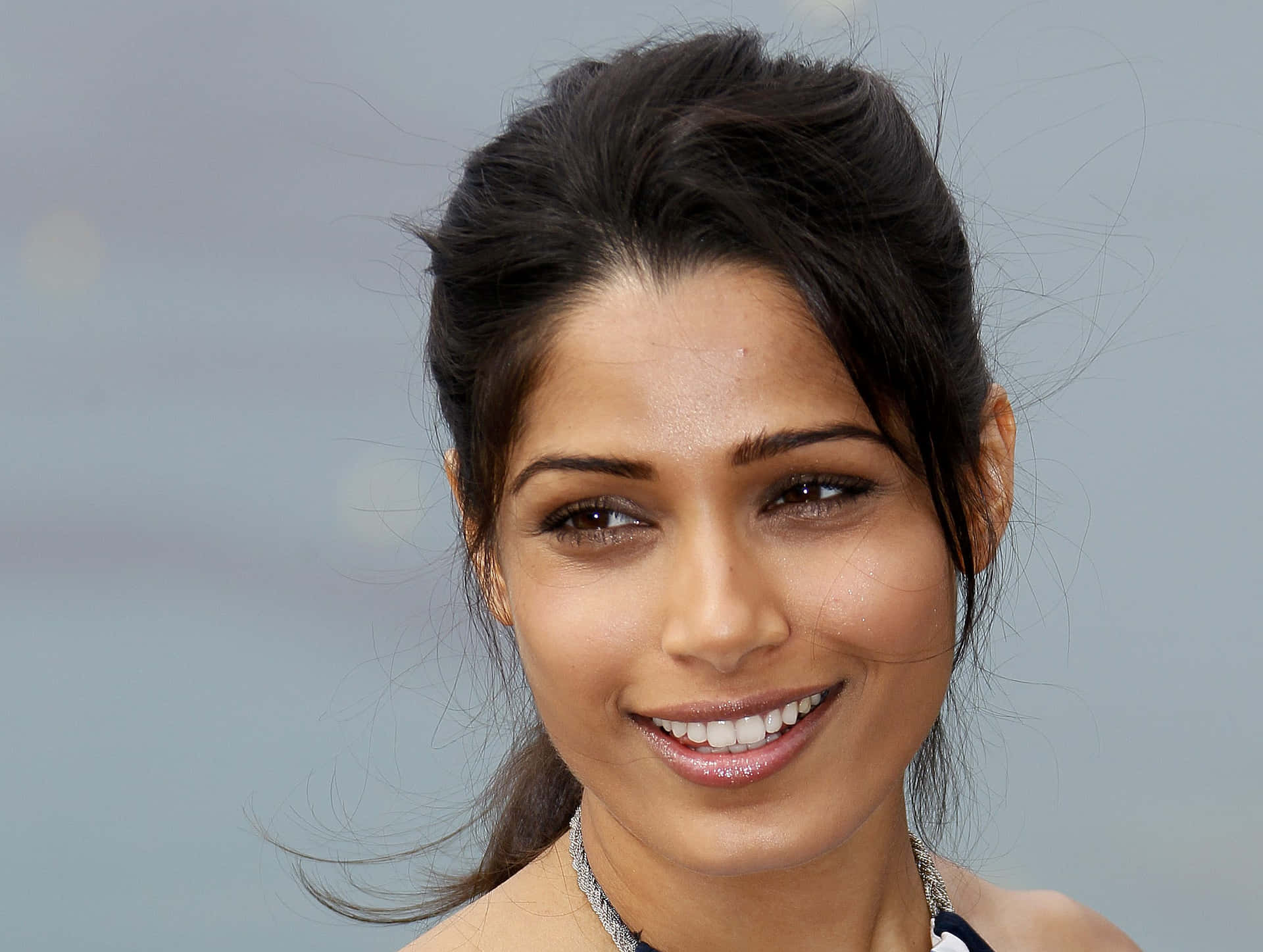 Freida Pinto Stuns in a Photoshoot against a Green Nature Backdrop Wallpaper