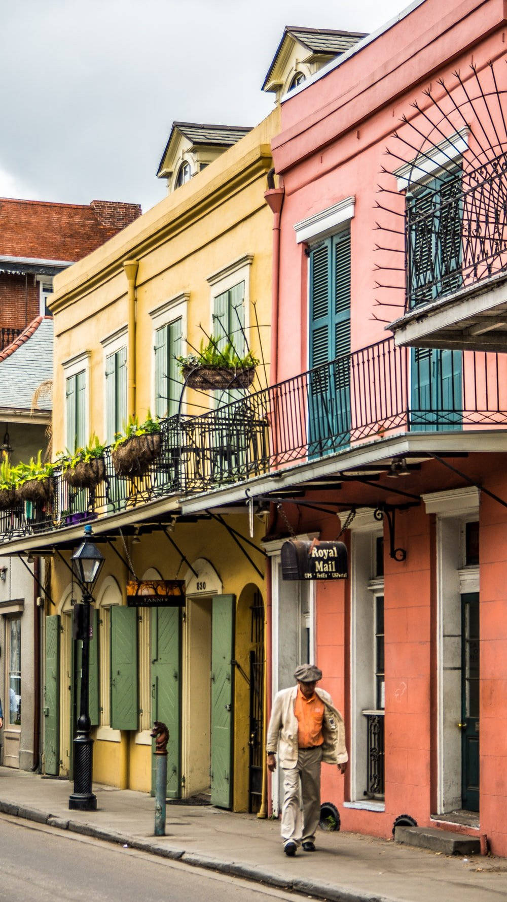 Caption: A captivating glimpse of a rustic sidewalk in the historic French Quarter. Wallpaper