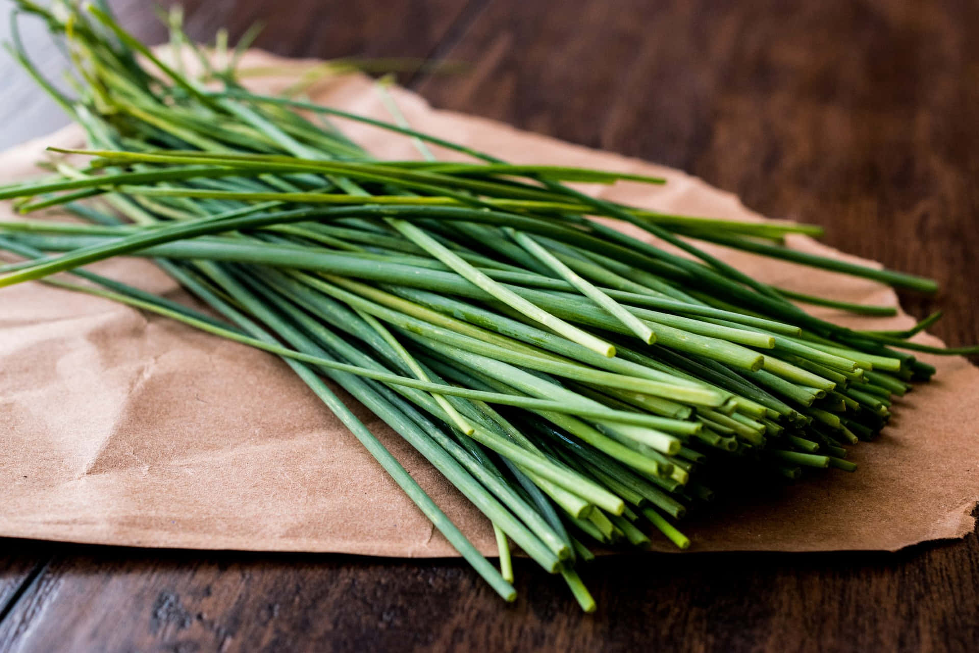 Fresh Green Chives On Brown Paper Wallpaper