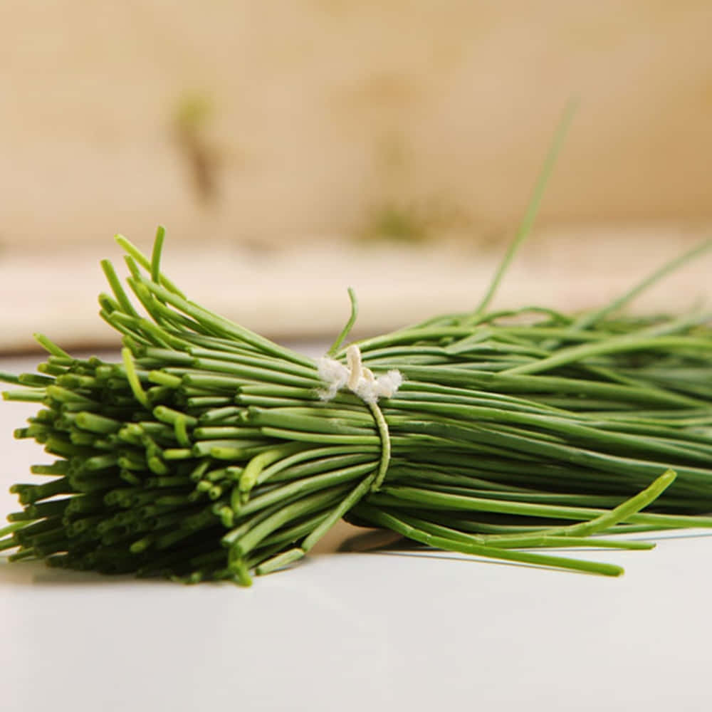 Fresh Green Chives Wrapped With White Thread Wallpaper
