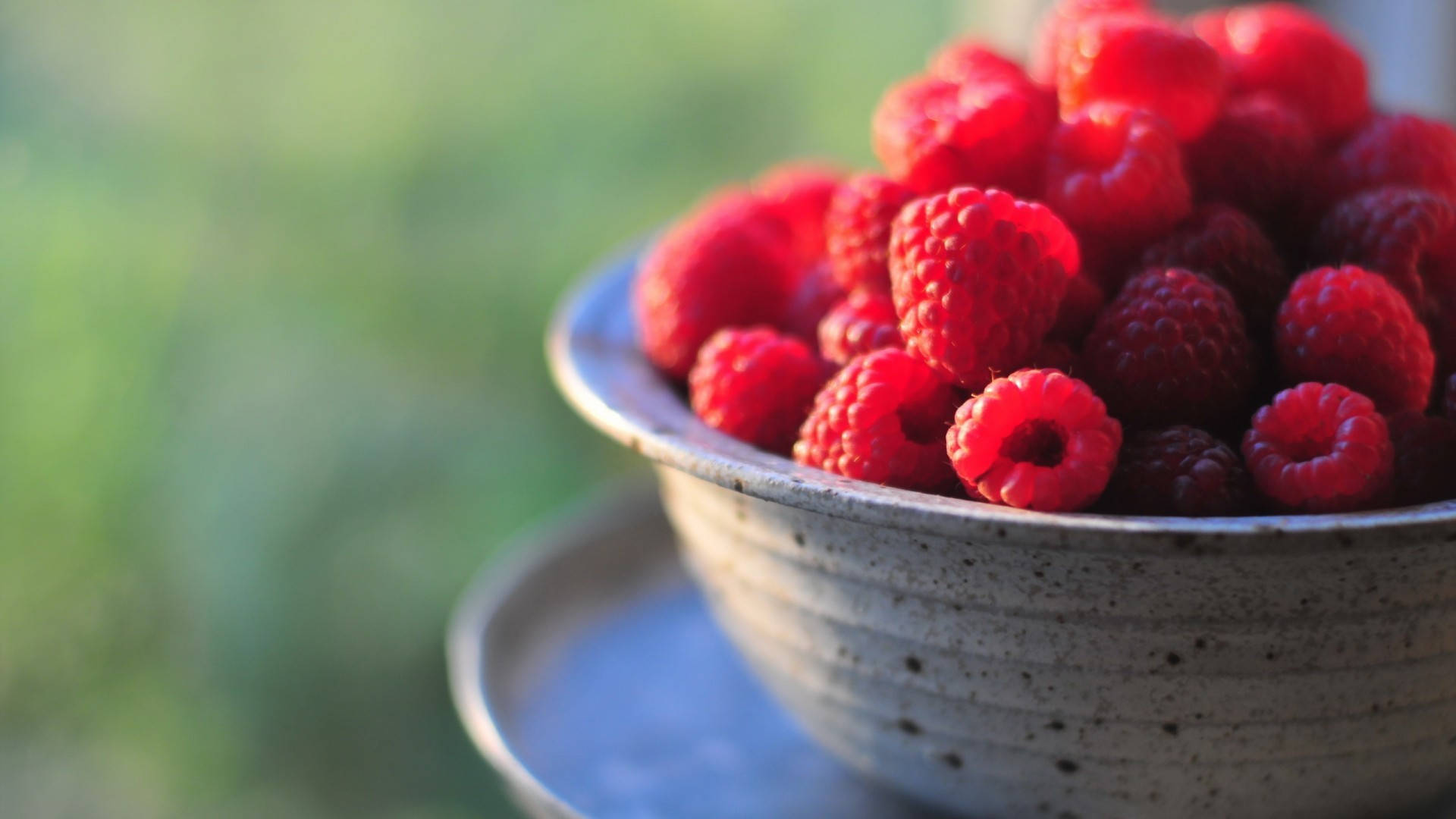 Fresh Raspberries In Stoneware Bowl Background
