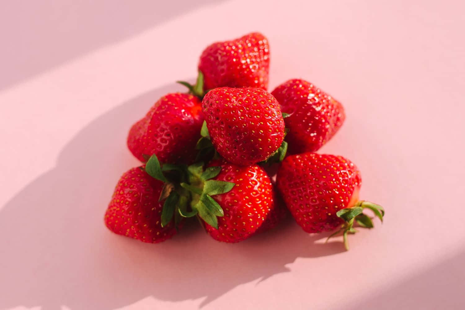 Fresh Strawberrieson Pink Background Wallpaper