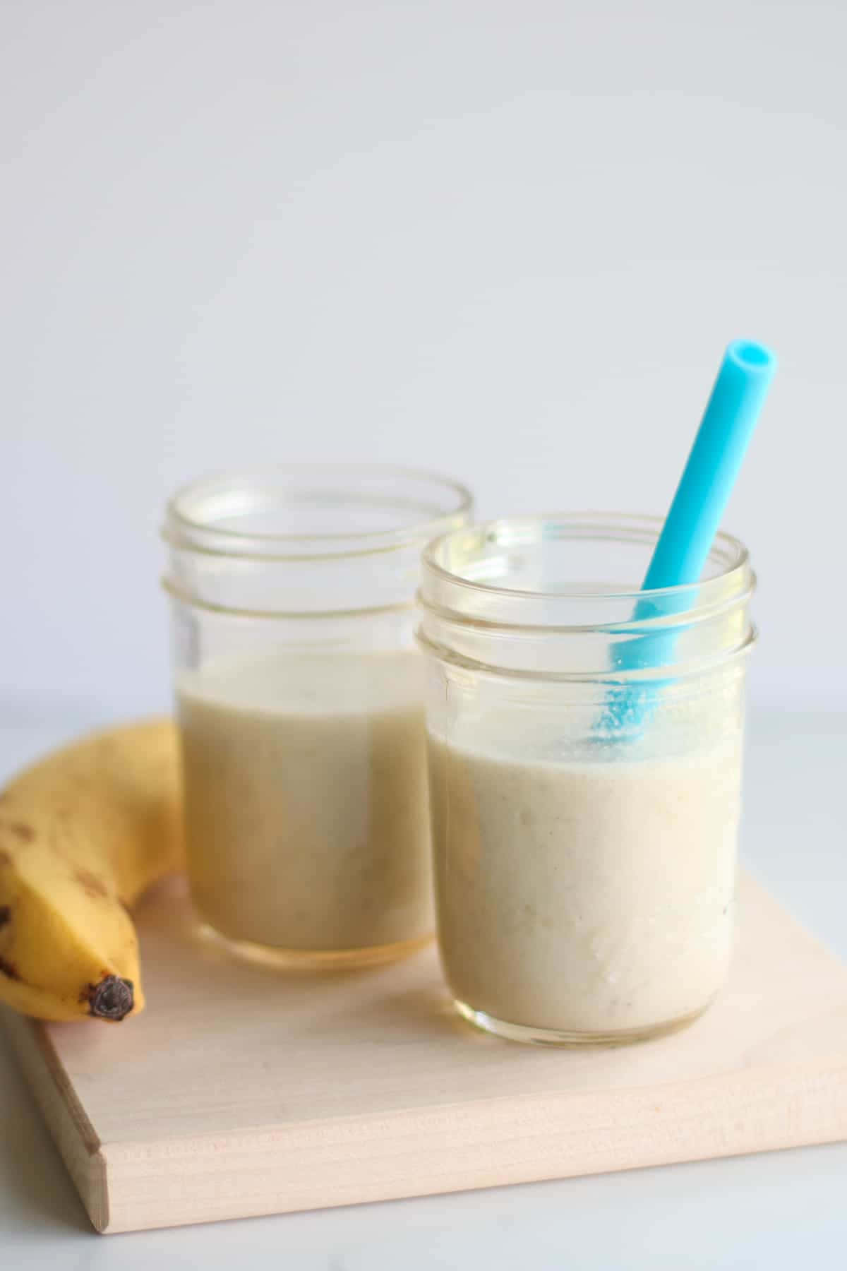 Fresh White Milk In A Glass Enveloped By Underlying Waves Of Cream