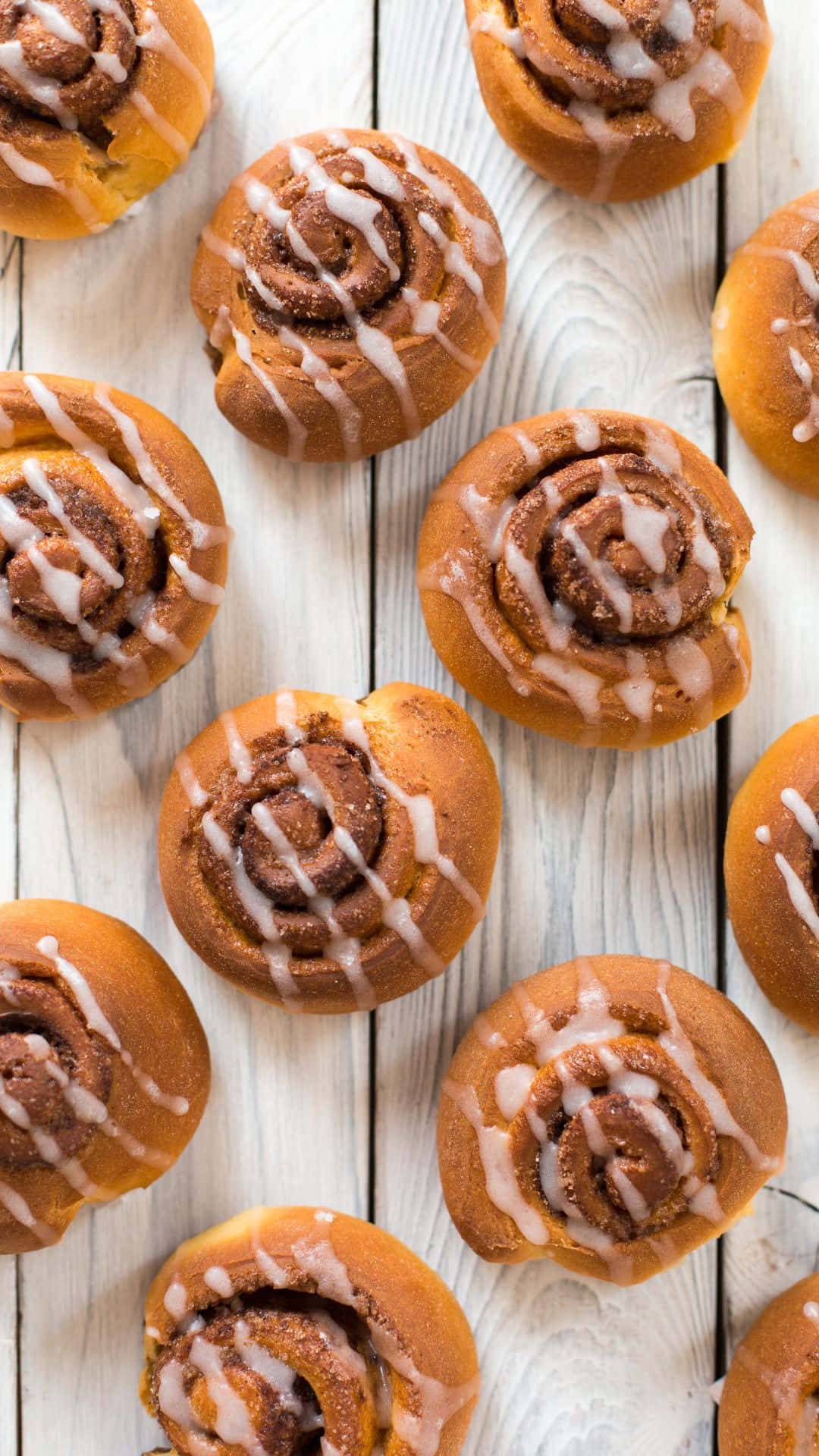 Freshly Baked Cinnamon Rolls With Icing Wallpaper