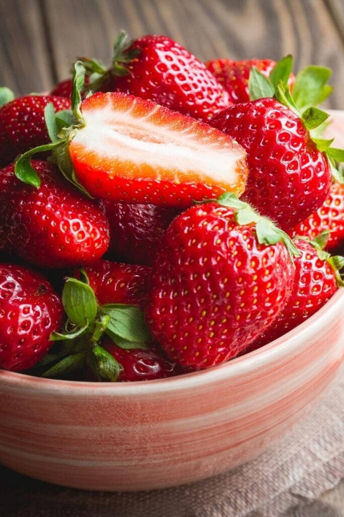 Freshly Picked Strawberries In Pink Bowl Background