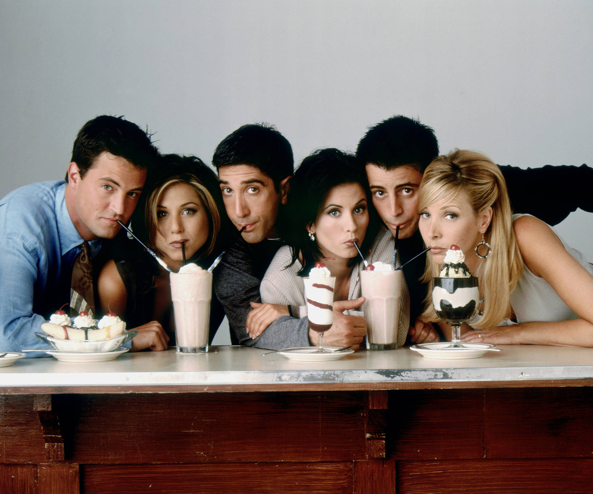 Friends Tv Show Cast Sharing Milkshakes Wallpaper