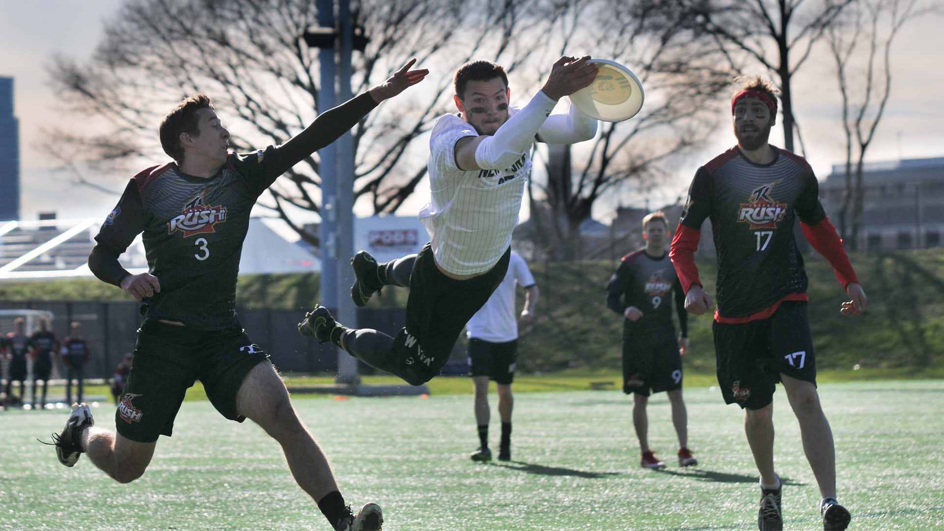 A Group Of Men Playing Frisbee