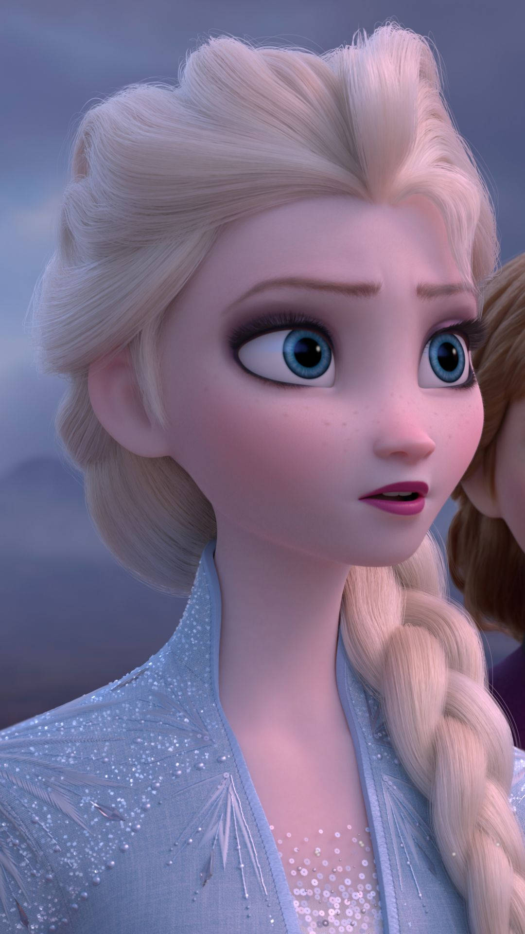 Anna and Elsa embracing in the beautiful winter wonderland Wallpaper