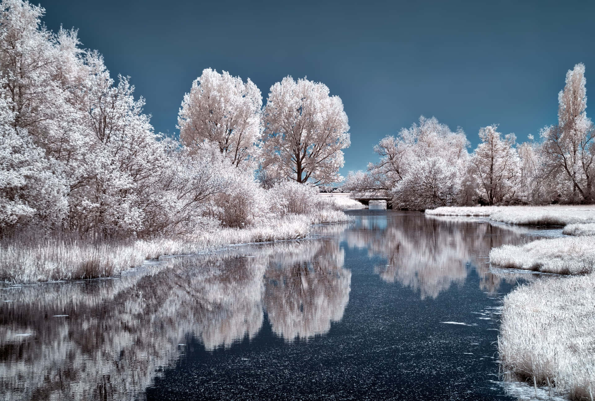 Download Stunning Frozen Lake Amidst Snow-Covered Landscape Wallpaper ...