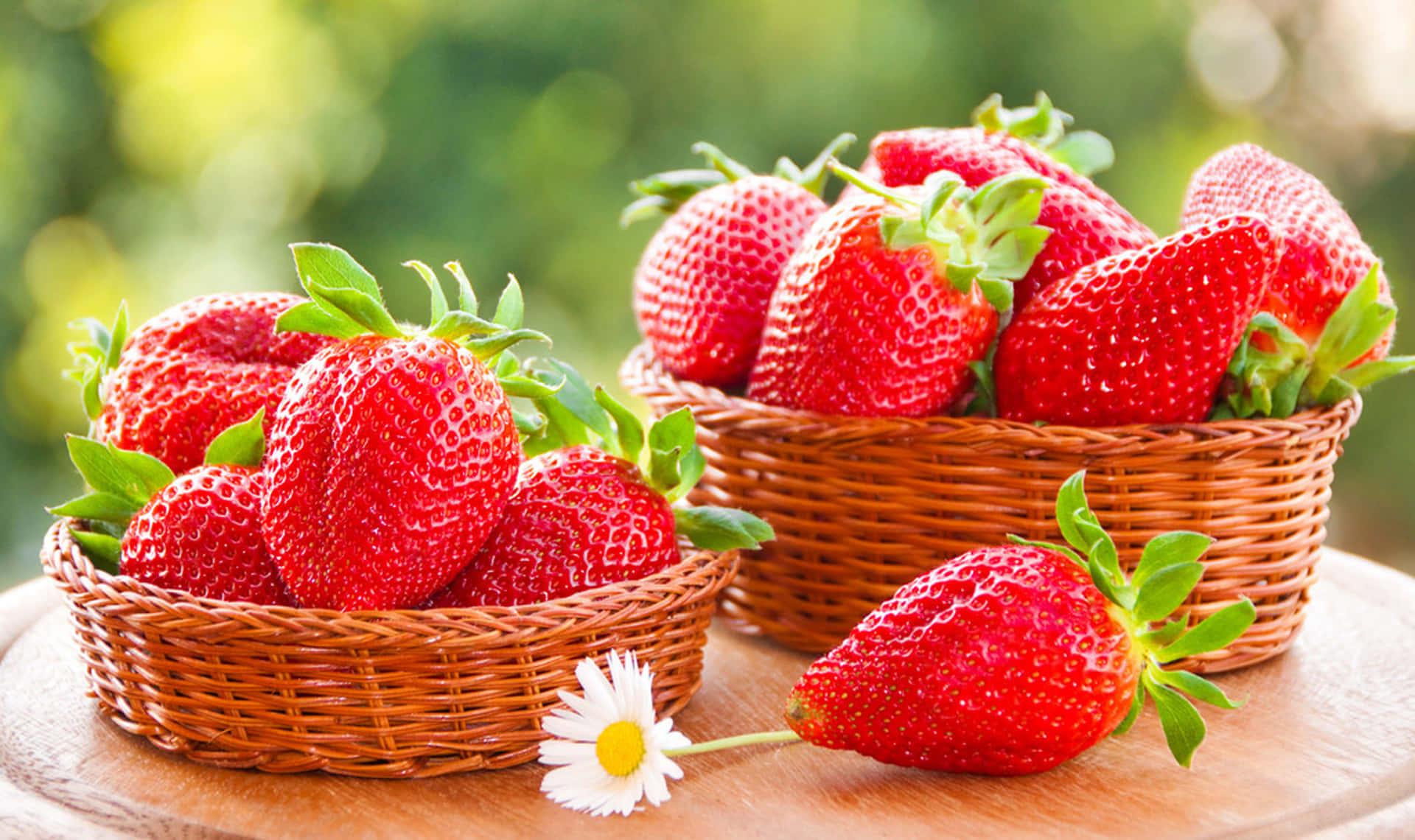 Two Baskets Of Strawberries On A Wooden Table