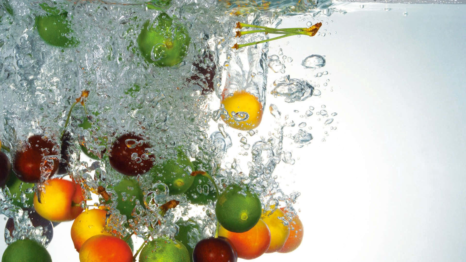 A Bunch Of Oranges And Grapes In The Water