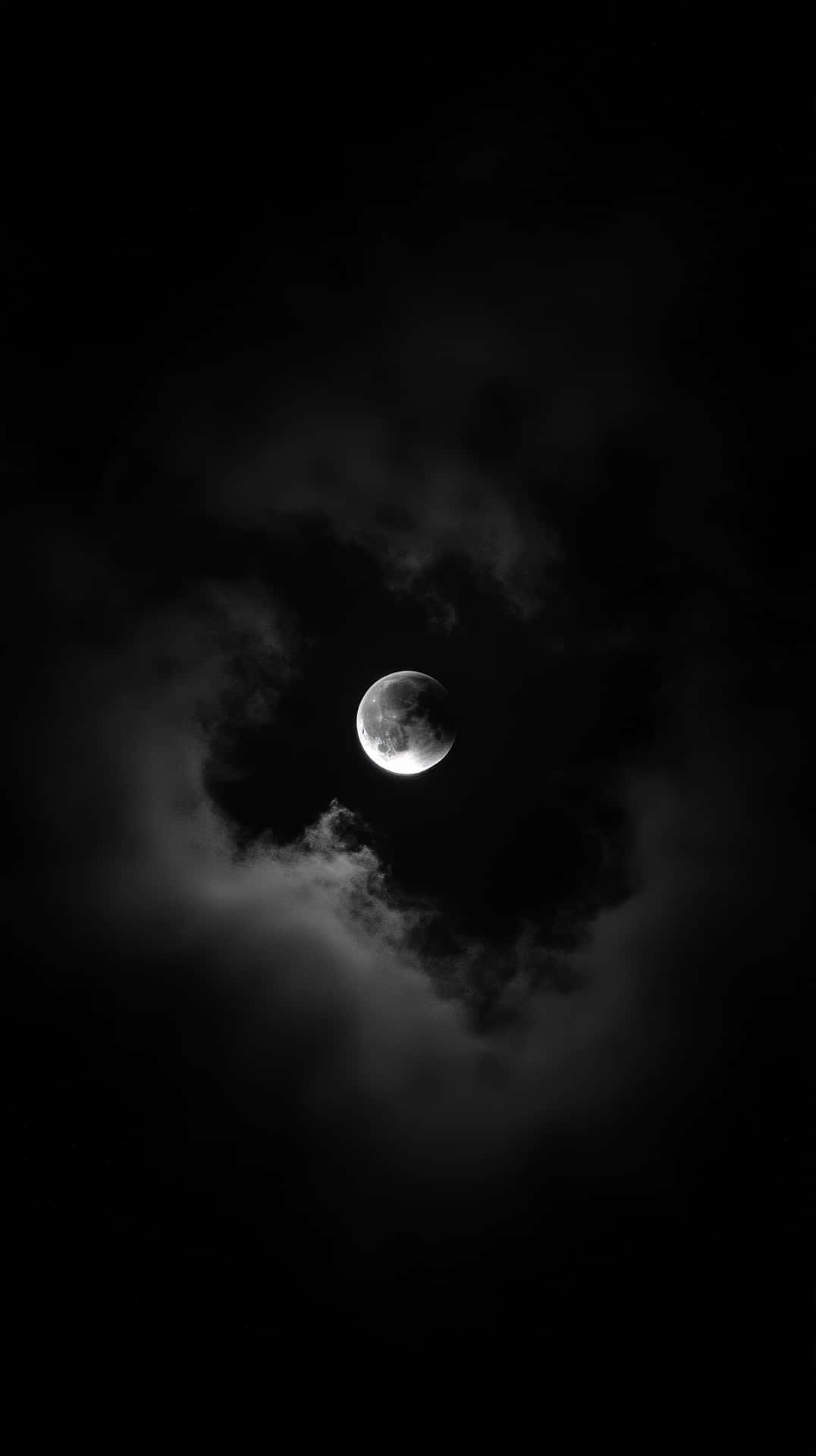 Full Moon Illuminating Dark Stormy Clouds In A Mysterious And Eerie Night Sky Wallpaper