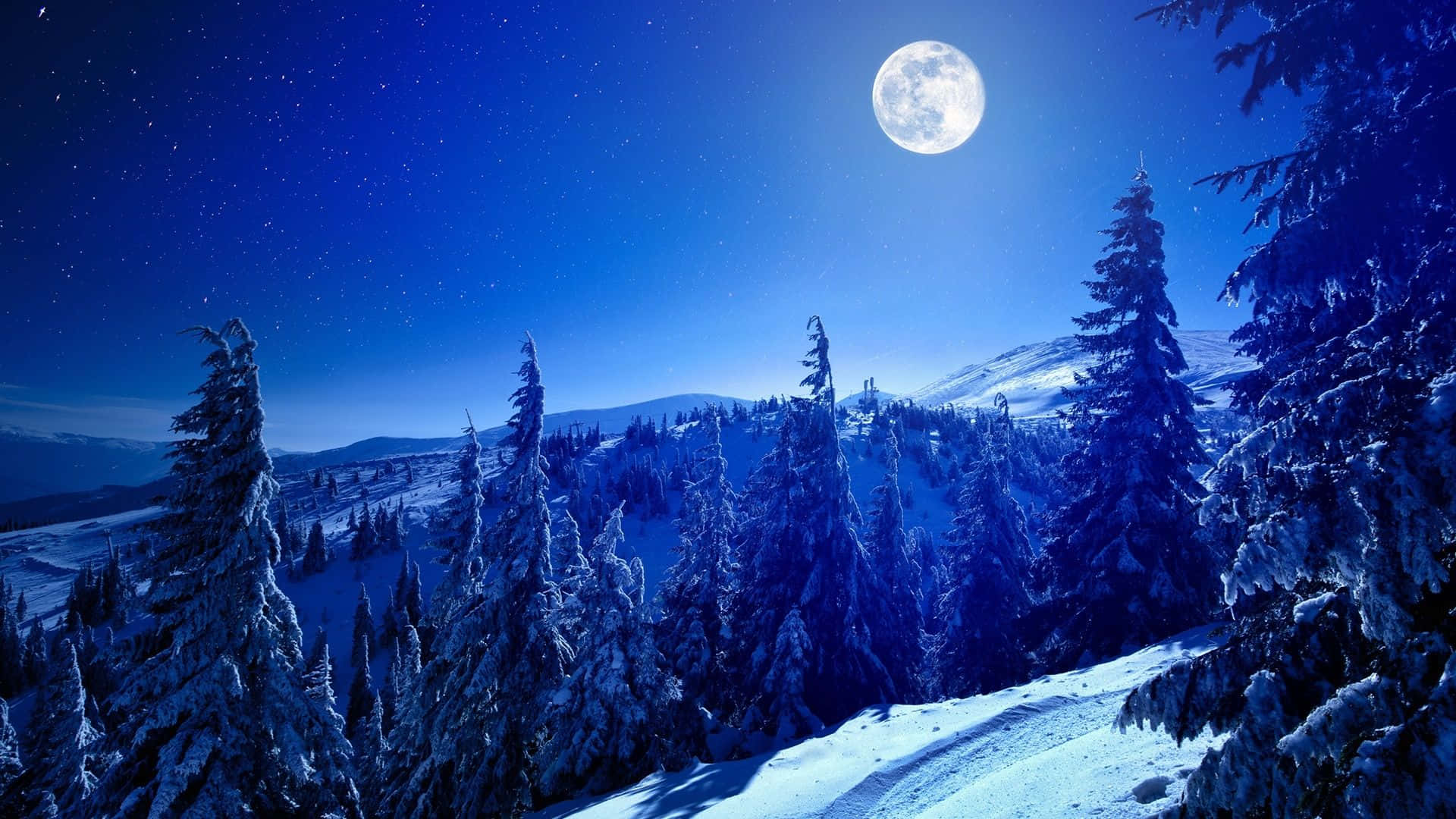 a snowy mountain with a full moon