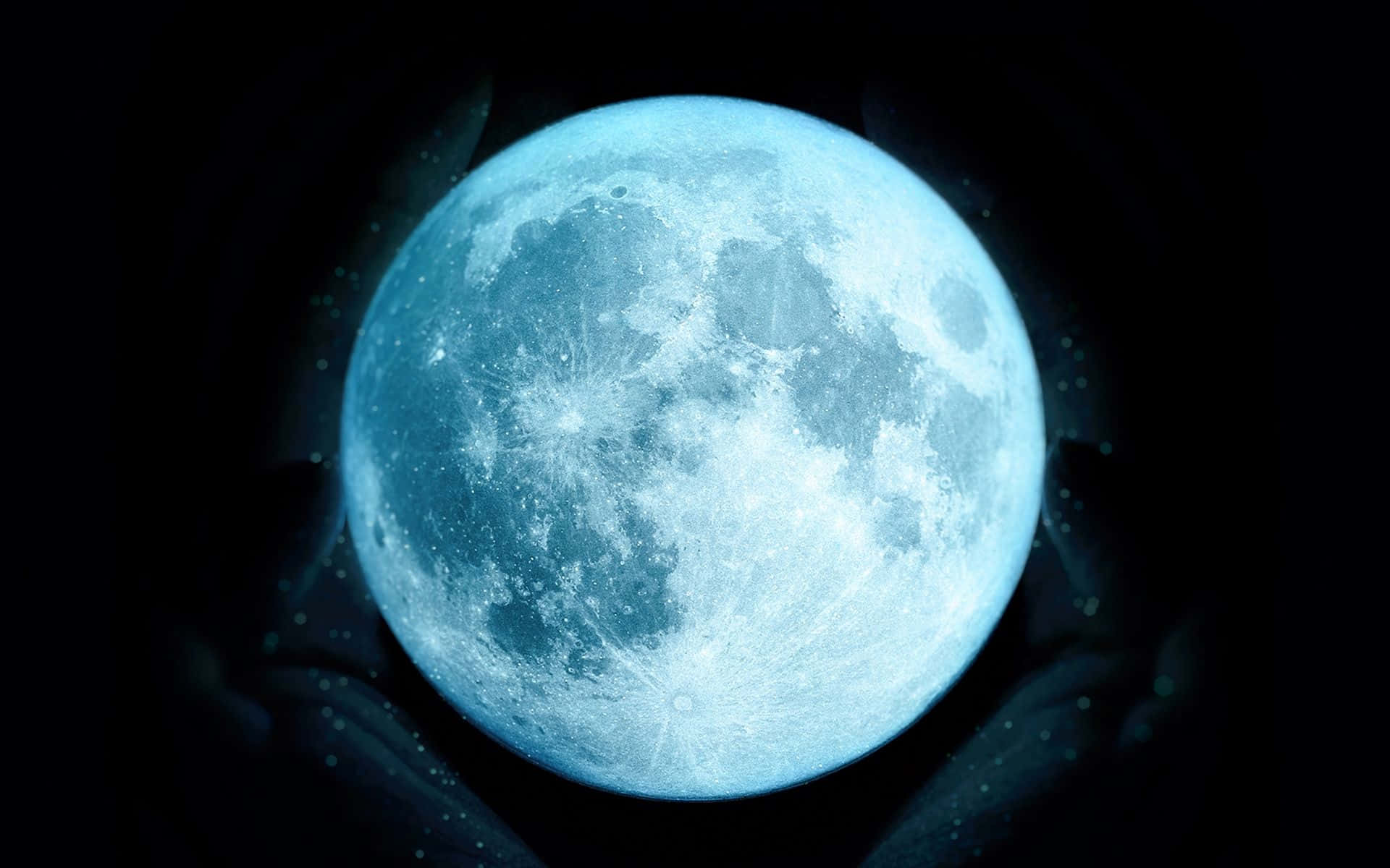 a blue moon with hands in the background