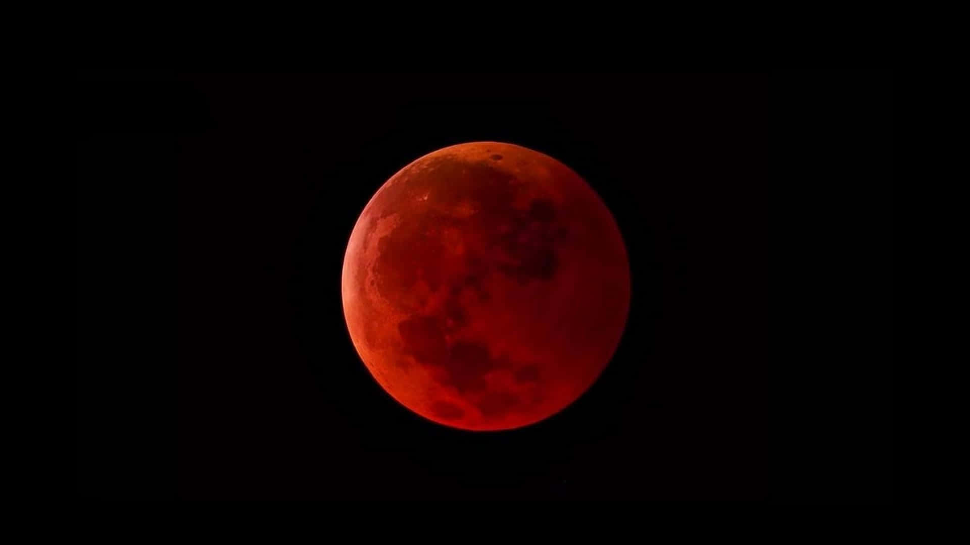 a red moon is seen in the sky