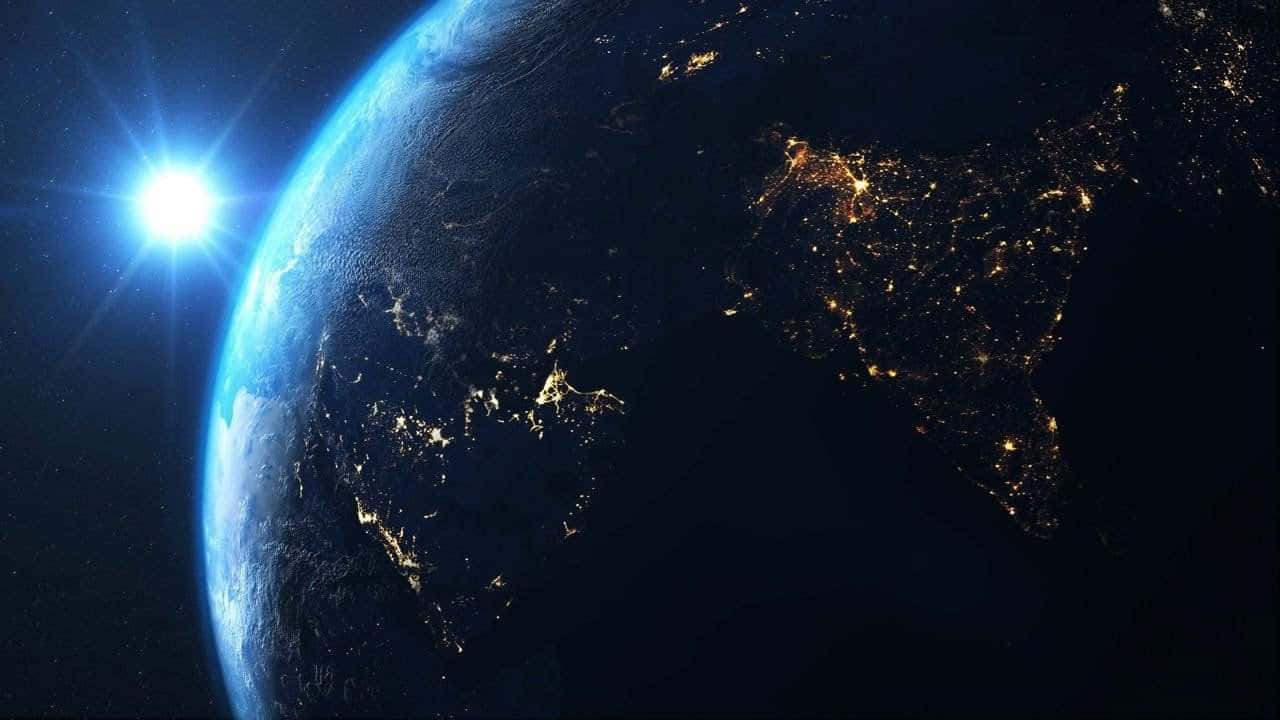 The Earth At Night With Lights Shining On It
