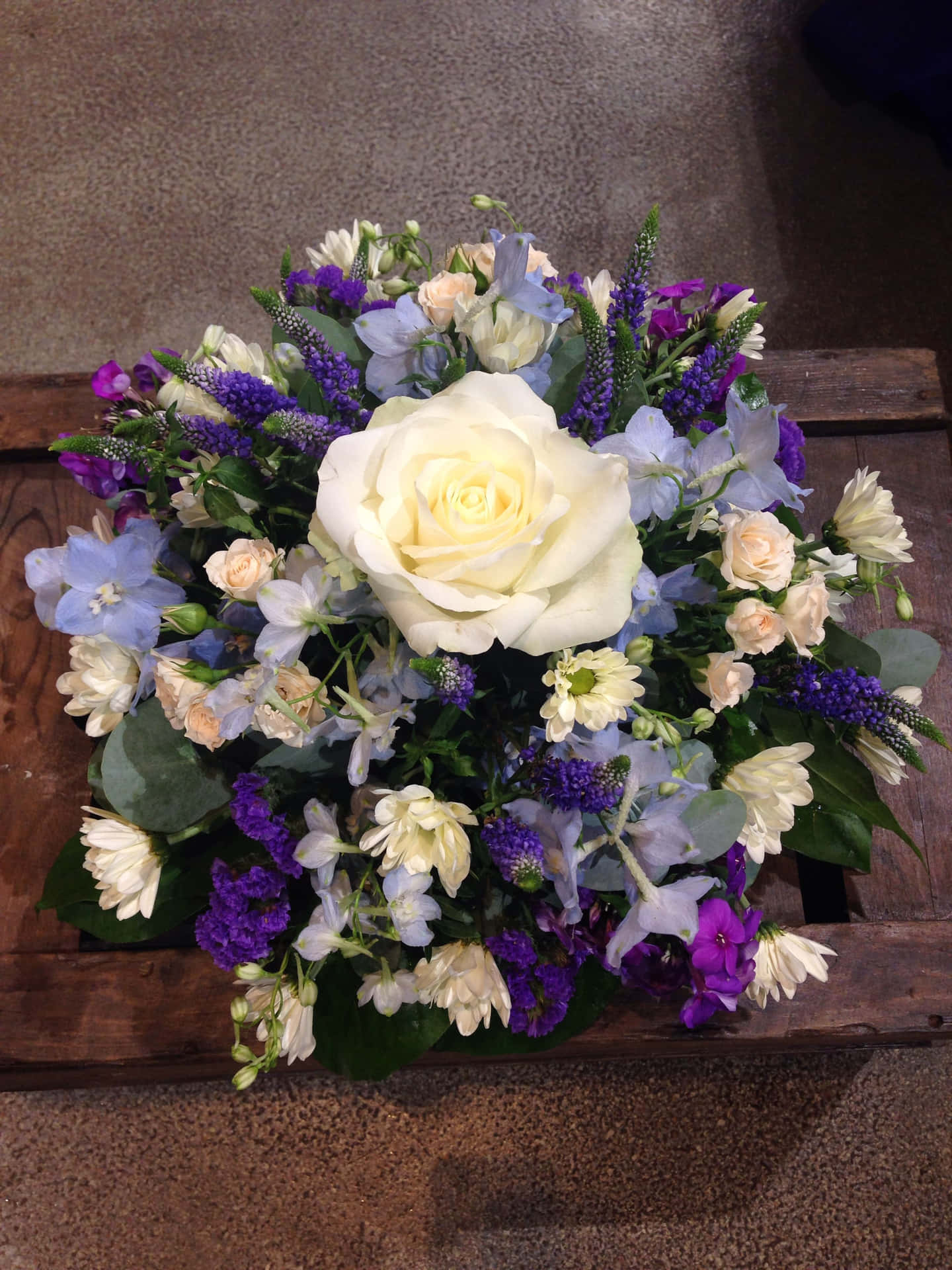 Colorful floral funeral arrangement to commemorate a loved one