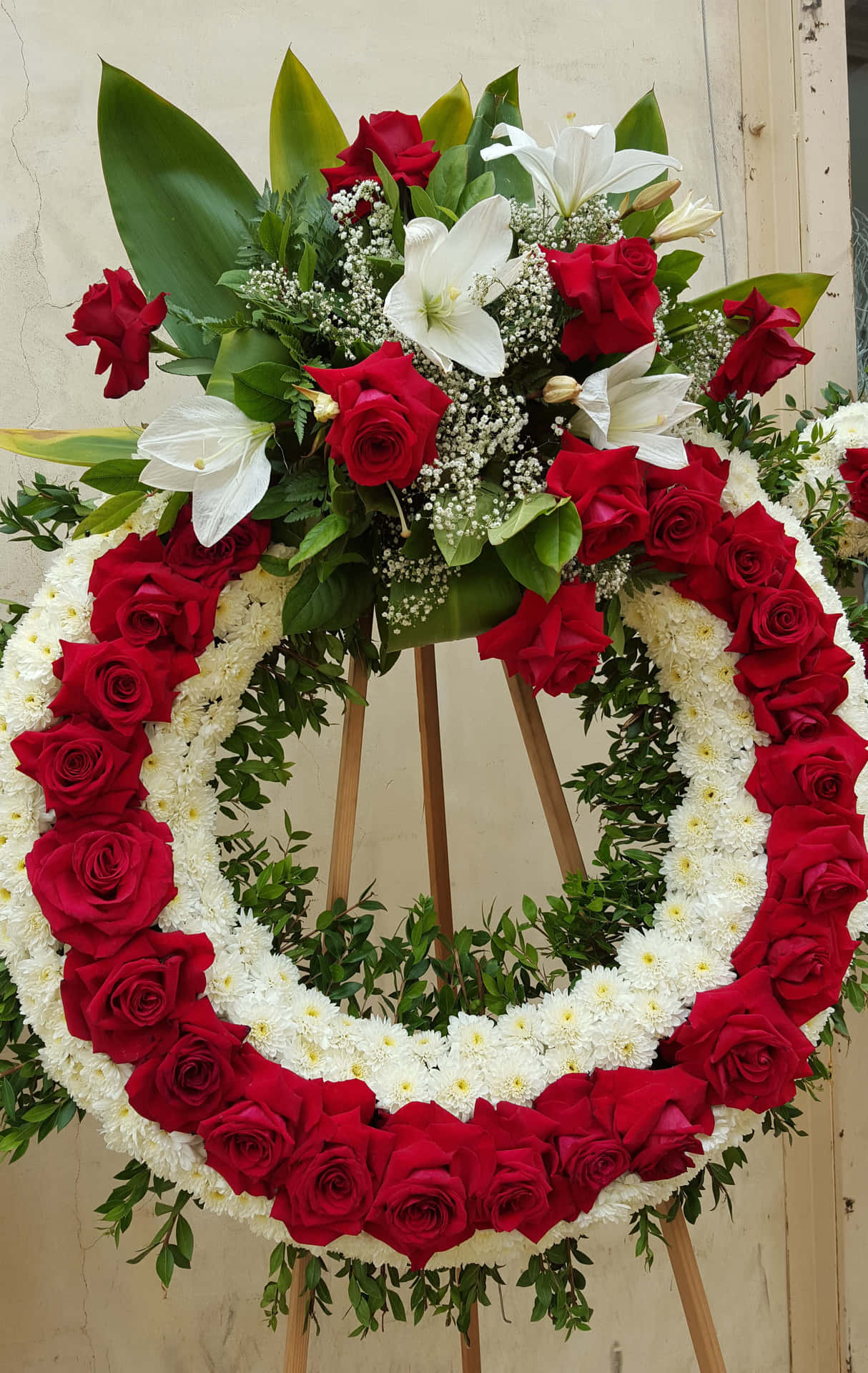 An abundance of warm-colored funeral flower arrangements offering tenderness and respect.