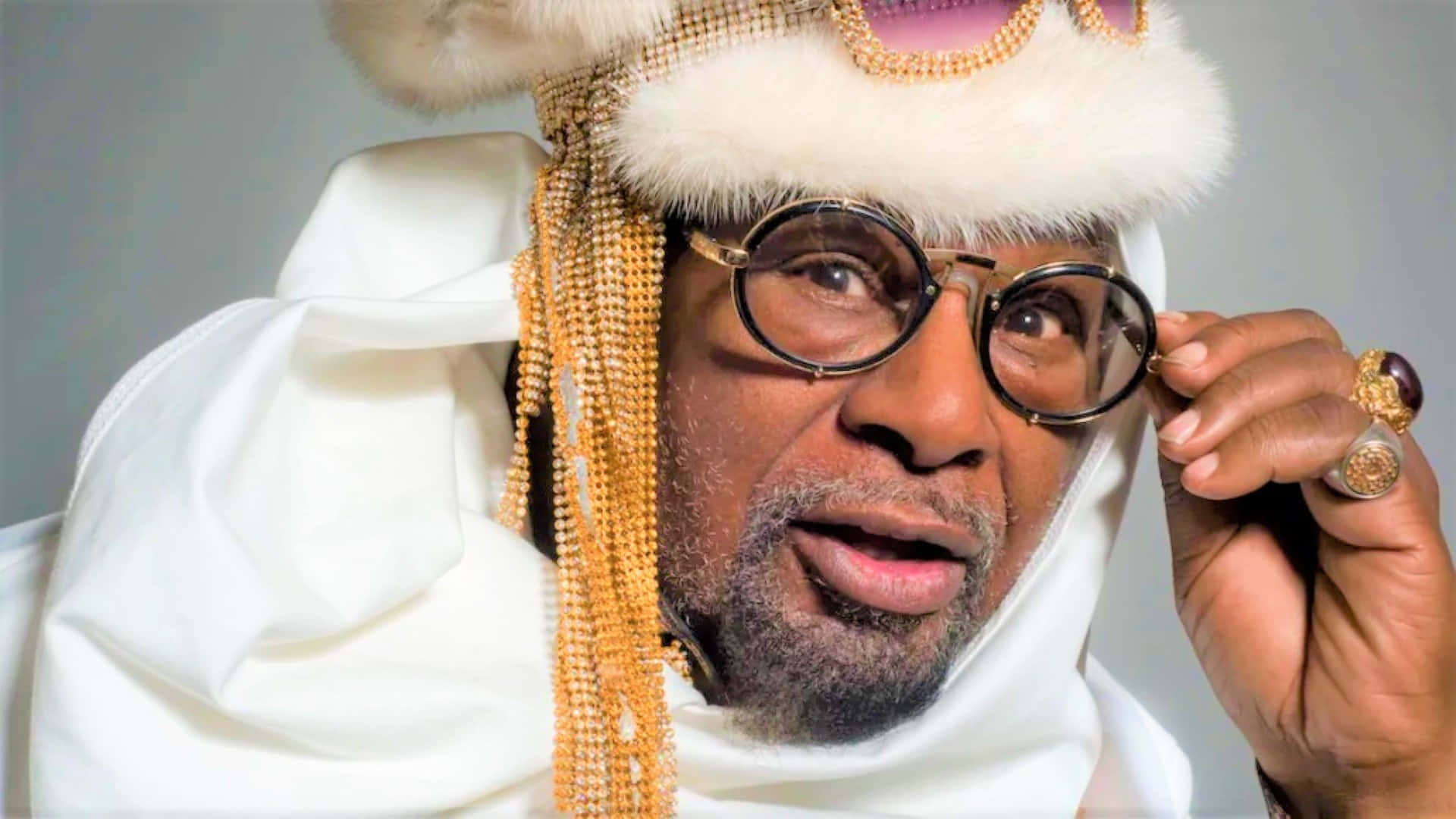 The Iconic Funk Maestro George Clinton Performing Onstage Wallpaper