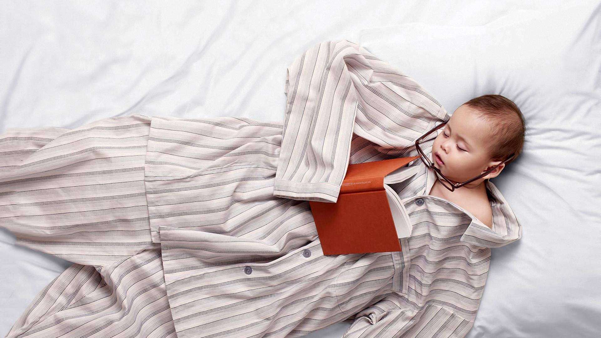 Funny Baby Sleeps In Big Pajamas Wallpaper
