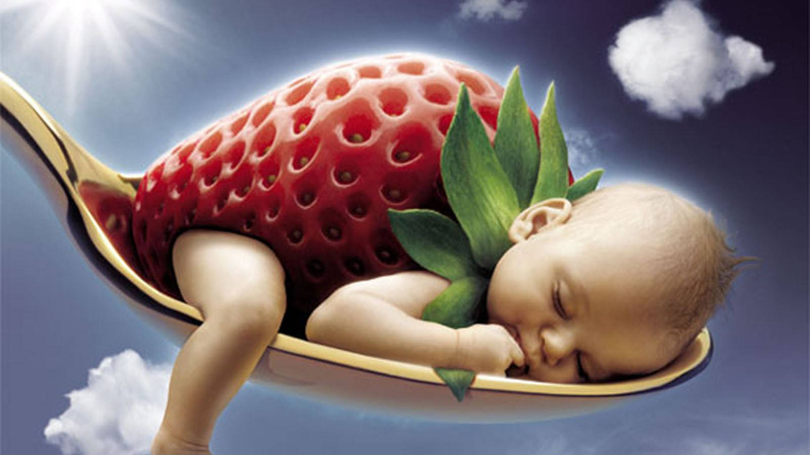 Adorable baby in a strawberry outfit laughing joyously Wallpaper