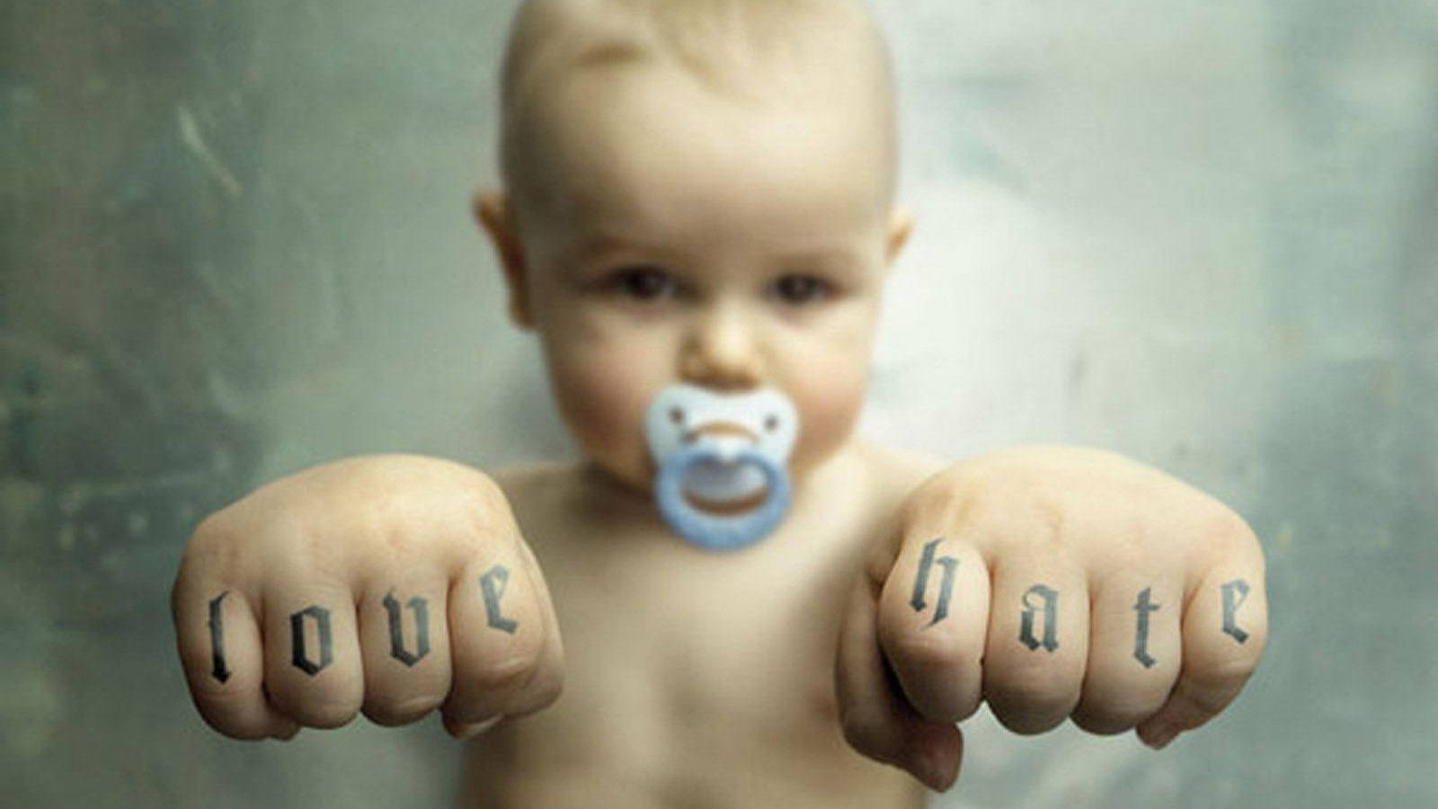 "Humorous shot of Baby with Tattooed Fist - adding a punch of fun to innocence." Wallpaper
