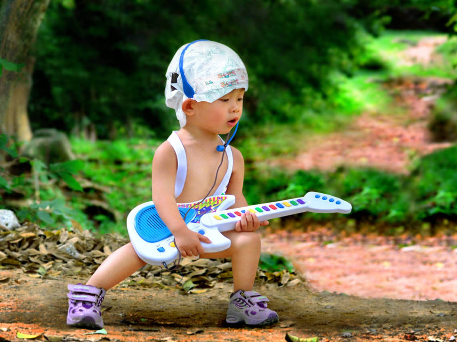 Engraçadobebê Com Uma Guitarra De Brinquedo. Papel de Parede