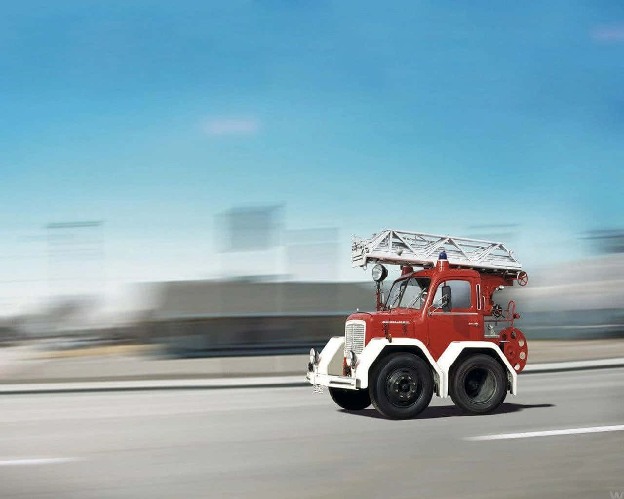 A Red Fire Truck Driving Down The Road