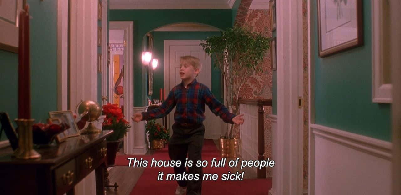 A Boy Is Standing In A Hallway With A Sign Saying This House Is So Full Of People Wallpaper