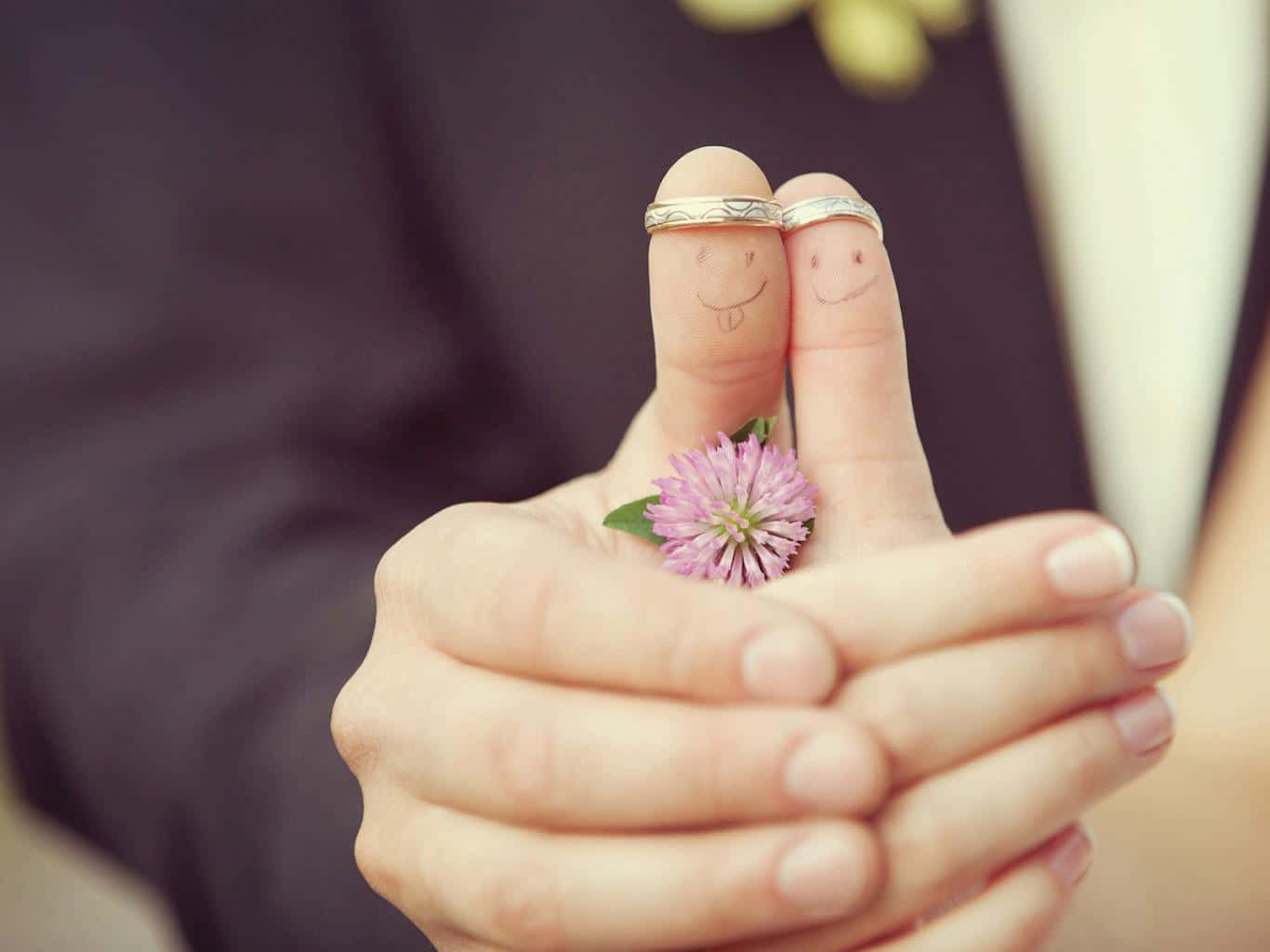 A Couple Holding Their Wedding Rings And Smiling Faces Wallpaper