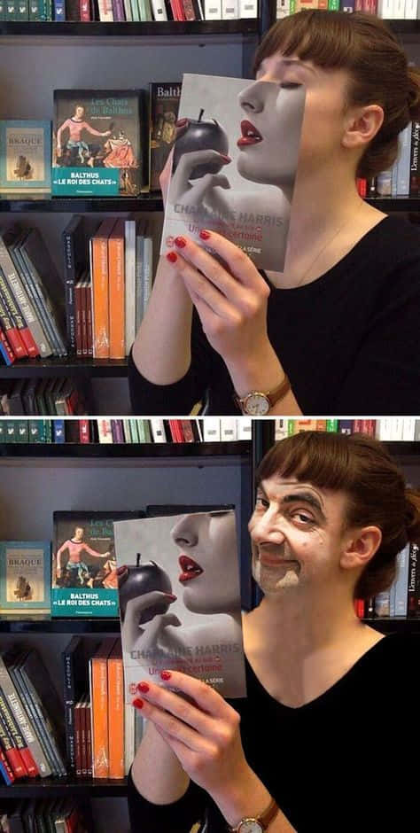 A Woman Holding A Book With A Face On It