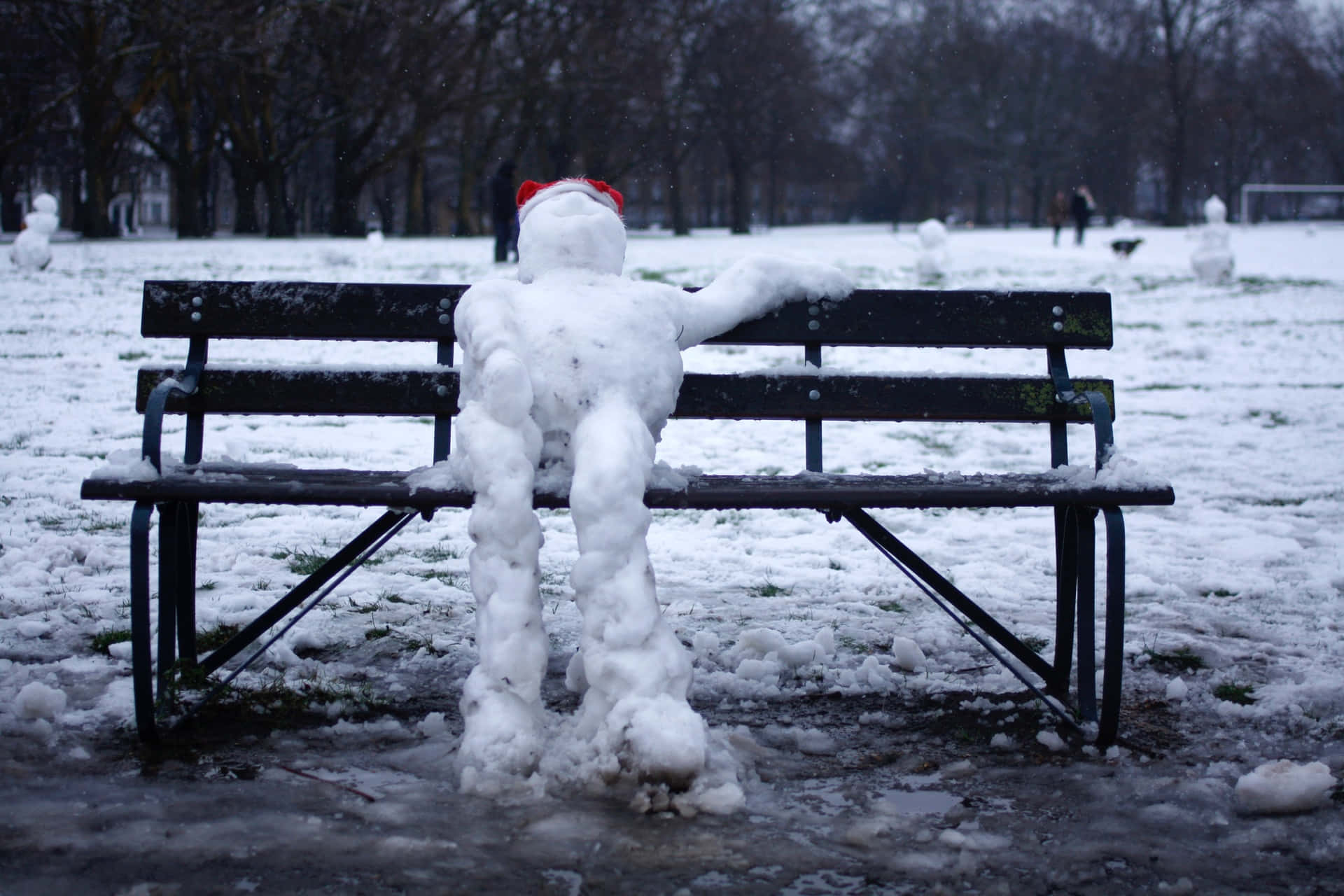 Funny Snow Man Sitting On Bench Picture