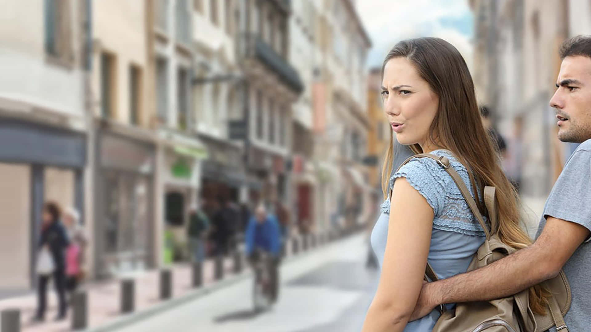 Download A Man And Woman Standing On A Street | Wallpapers.com