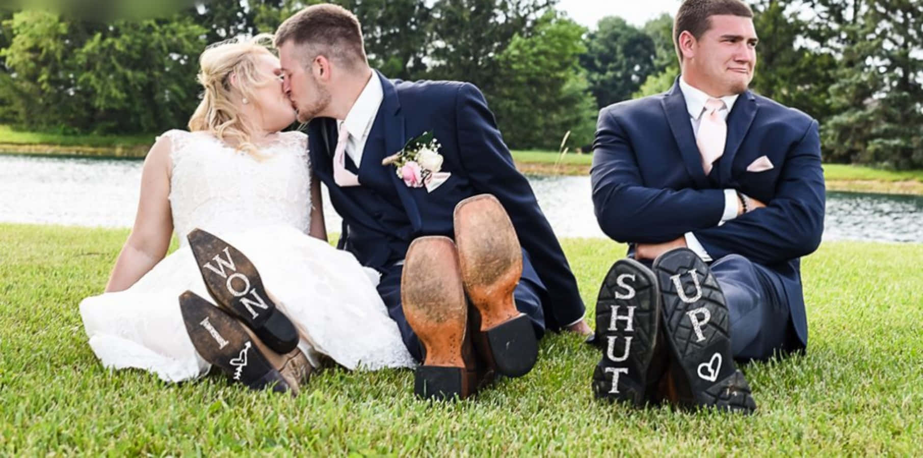 A Bride And Groom Kissing In The Grass