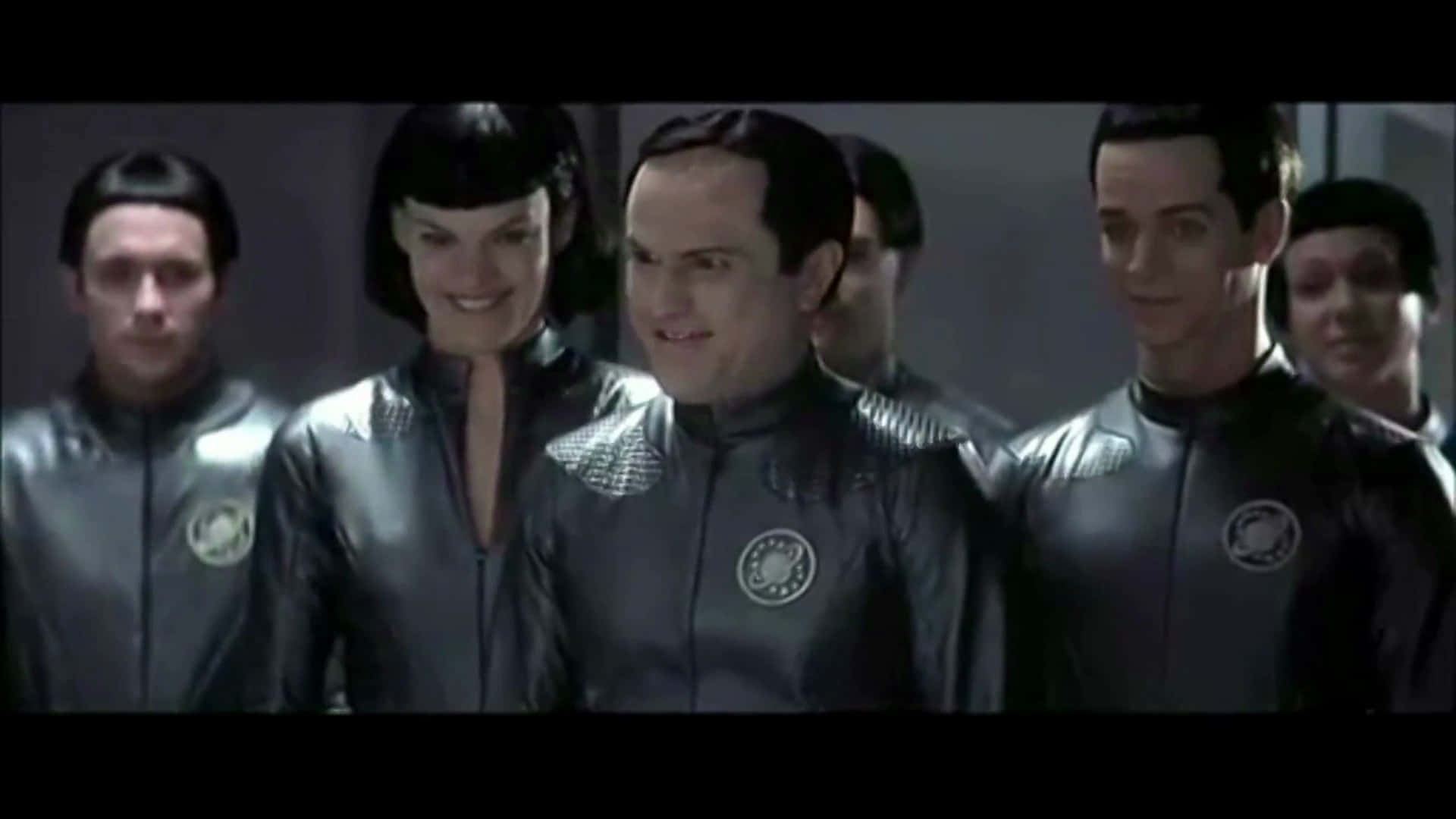 The valiant crew of NSEA Protector aboard their spaceship from the iconic film Galaxy Quest Wallpaper