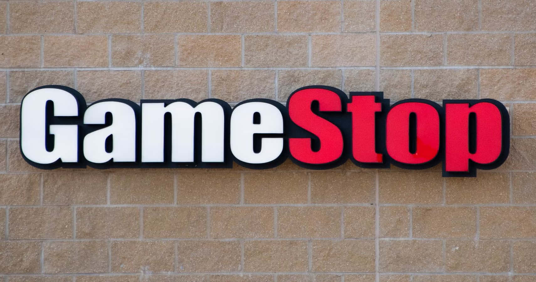 A Sign For Gamestop Is Seen On A Building