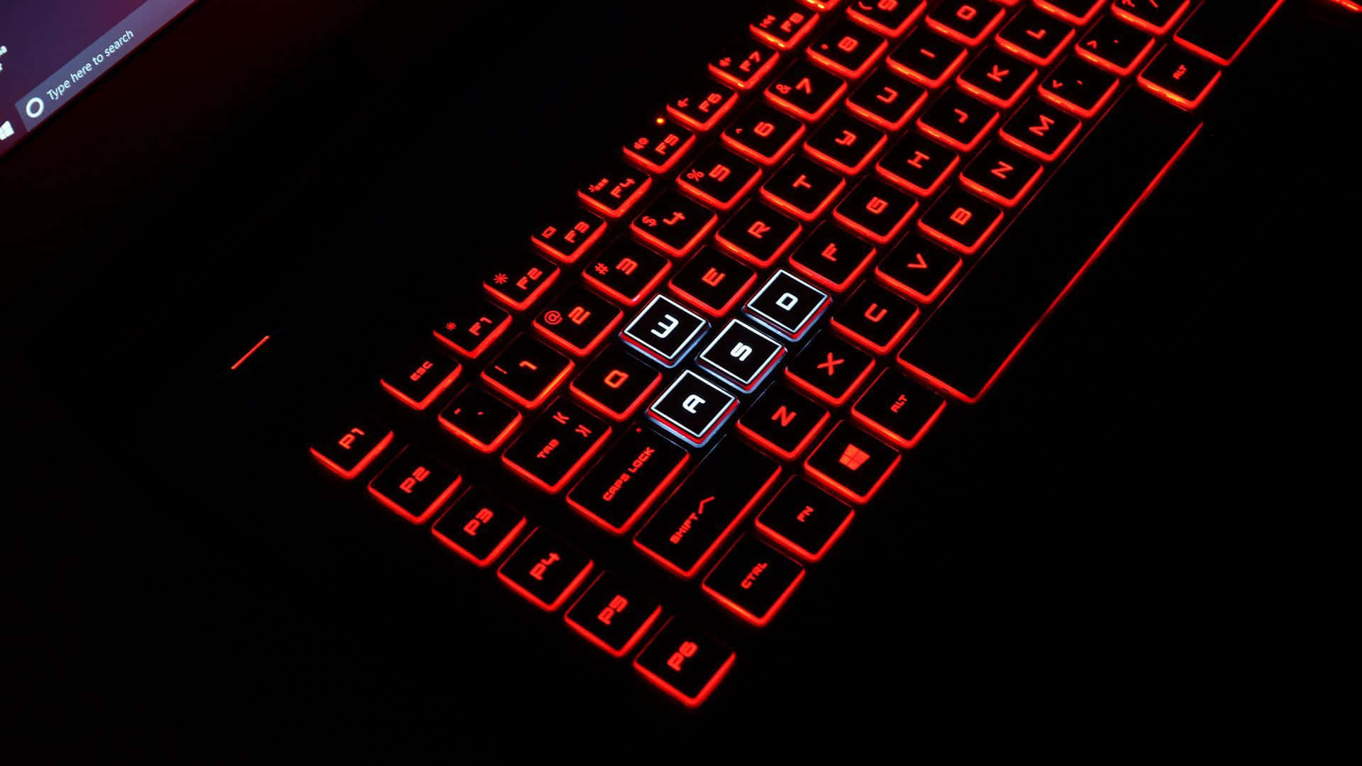 A Laptop Keyboard With Red Lights