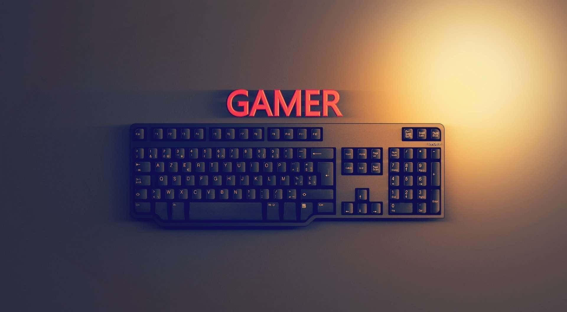 A Computer Keyboard With The Word Gamer On It