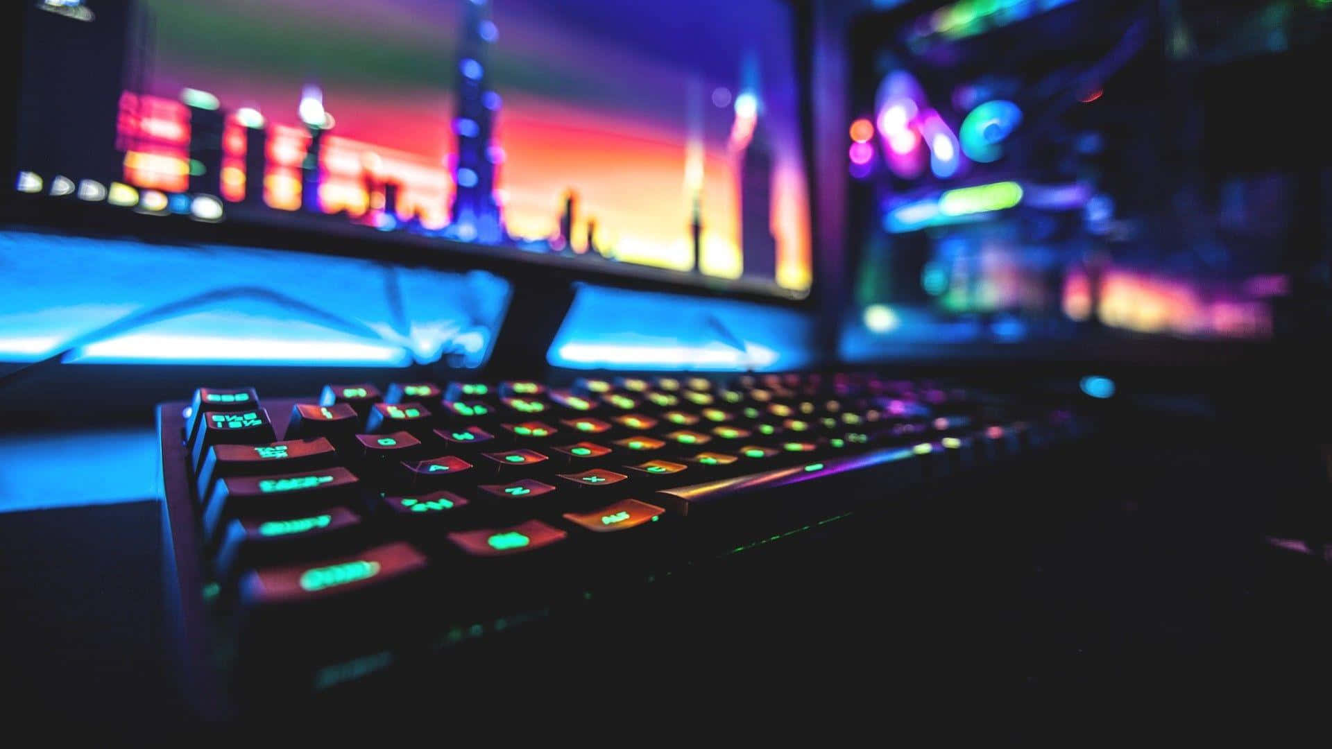 A Computer Keyboard With Colorful Lights In Front Of A Monitor