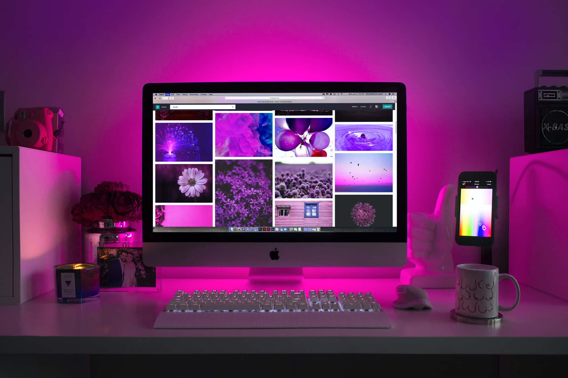 A Computer Monitor With Purple Lights On It